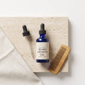 Pure Wash beard growth oil bottle with dropper, close-up of natural ingredients and sleek packaging for beard grooming.
