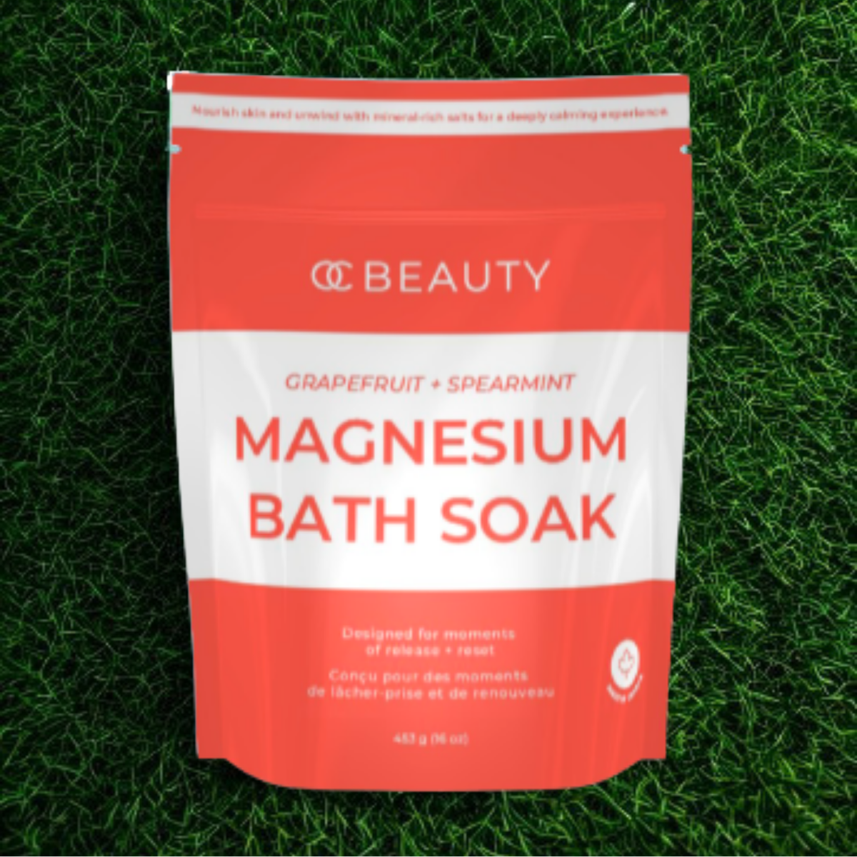 OC Beauty Co. Grapefruit and Spearmint Magnesium Bath Soak in a jar, with fresh grapefruit slices and spearmint leaves beside it.