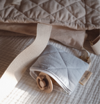Reusable Dans Le Sac quilted cotton coin purse with a soft, padded fabric design and compact shape.
