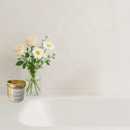 Rose Radiance floral magnesium and mineral-rich bath salts from The InnerCandescent Co in a clear container with pink and white salts.