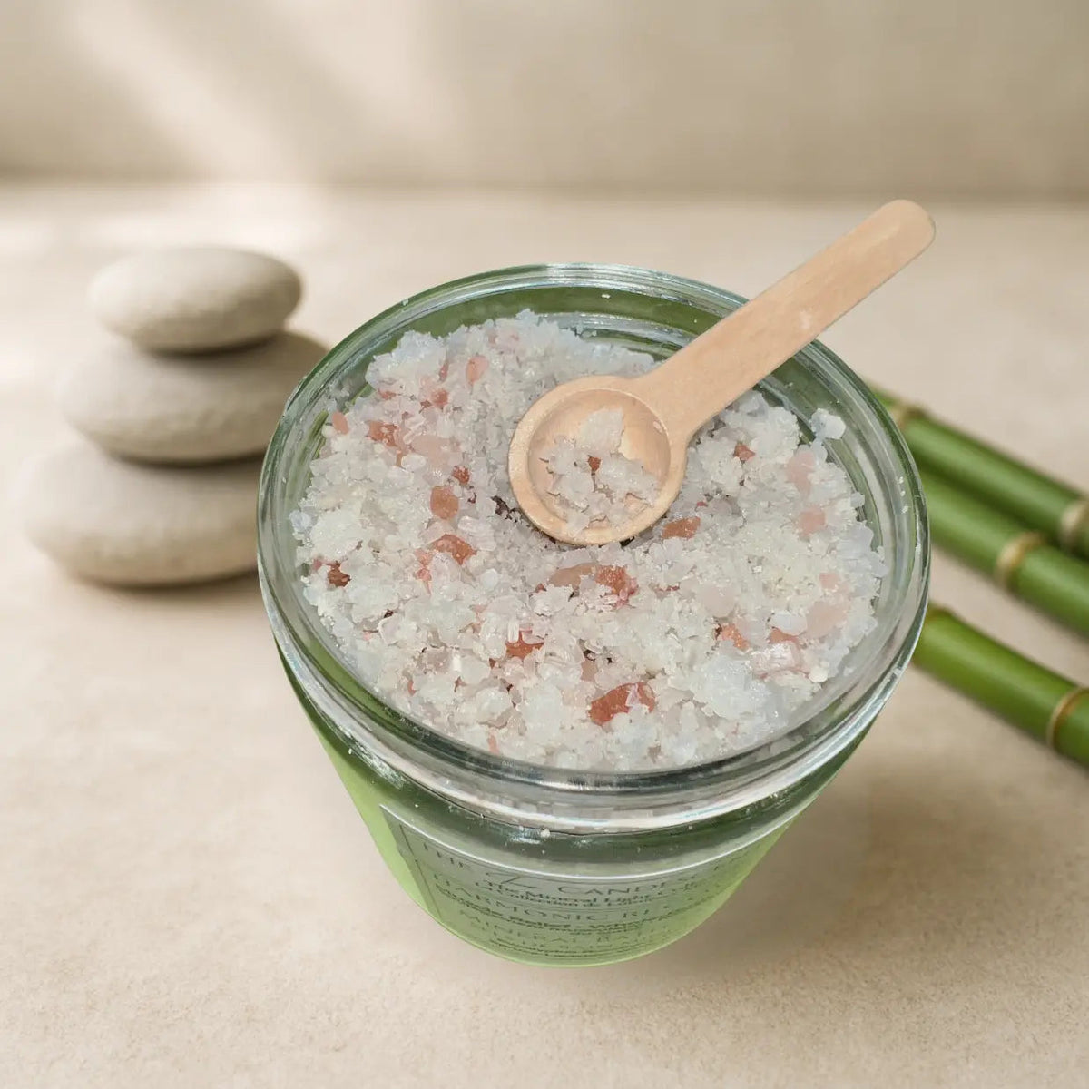 The InnerCandescent Co Rose Radiance floral magnesium mineral bath salts for foot soaks in a clear jar with pink and white salts.