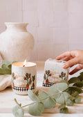 Alpes reusable 8oz candle by Mimi & August featuring a sleek glass container and a natural wax finish.
