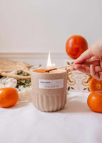 Amalfi reusable candle by Mimi & August in an 11 oz glass jar with a wooden wick and a minimalist label design.
