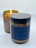 Aqua Solace water element candle by The InnerCandescent Co with a lit flame, featuring a fresh aquatic scent with coconut and apricot wax.