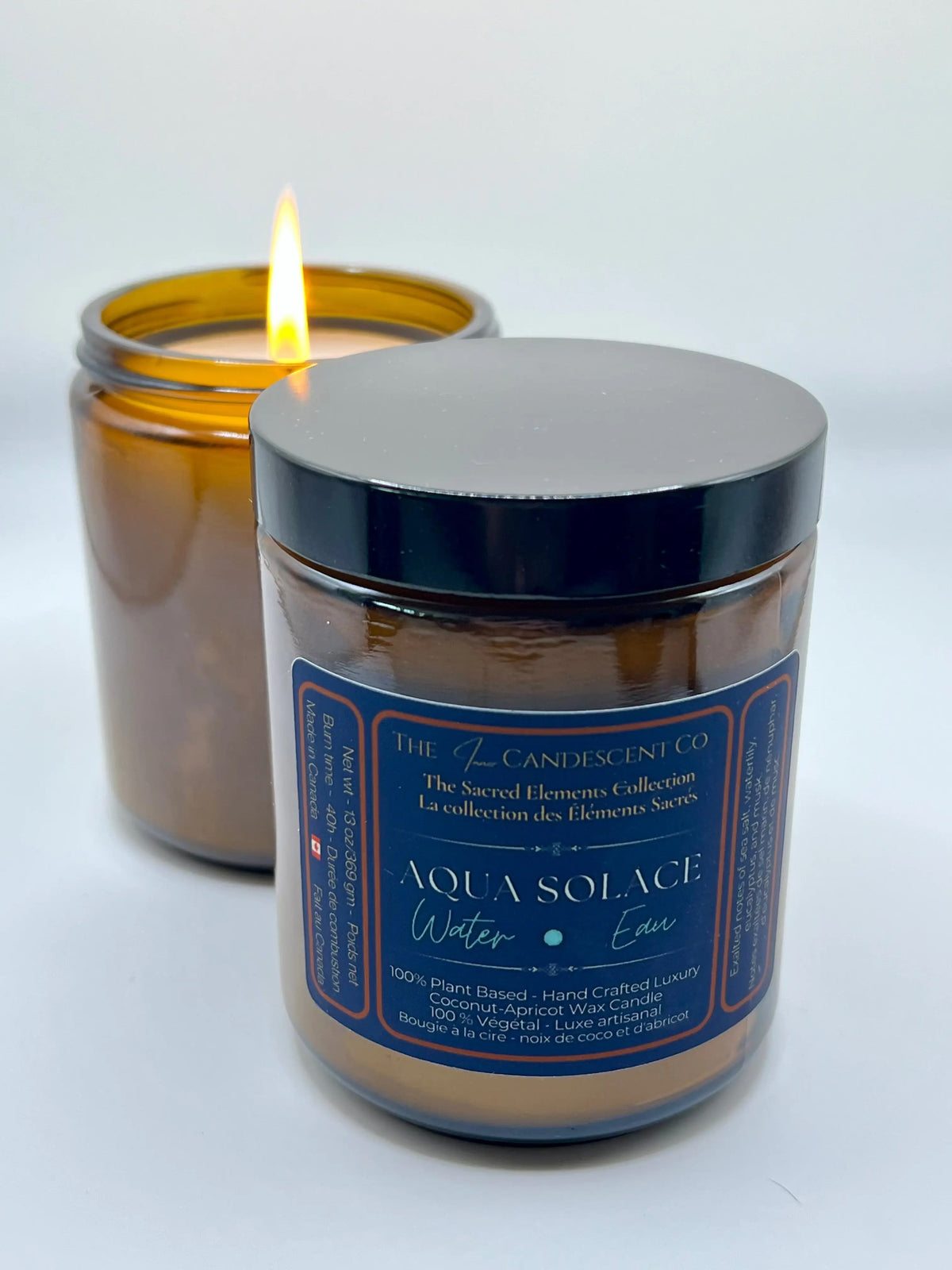 Aqua Solace water element candle by The InnerCandescent Co with a lit flame, featuring a fresh aquatic scent with coconut and apricot wax.