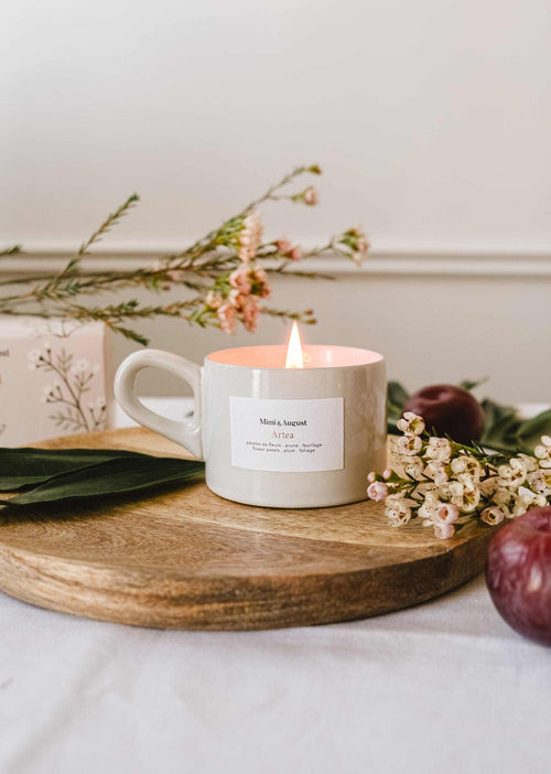 Mimi & August Artea reusable soy candle in a 5oz glass jar, featuring a minimalist label and a lit wick.
