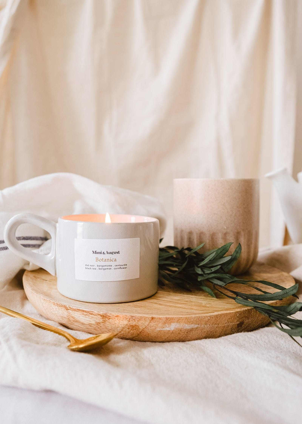 Botanica reusable candle by Mimi & August in a 5oz glass jar with a natural botanical design and a white wax finish.