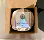 Open box of The InnerCandescent Co CELESTIAL NOEL luxury coconut apricot wax candle, showcasing its elegant packaging and floral design.