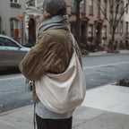 Reusable corduroy croissant bag with adjustable strap and zipper closure by Dans Le Sac, featuring a stylish, compact design.