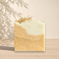 Gentle NÉFERTITI soap by La Sultana Savonnerie with beeswax, turmeric, and calendula, shown as a natural bar of soap.