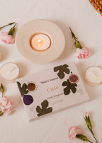 Set of Mimi & August Cielo tealight candles in wax tart form, displayed in a decorative arrangement.