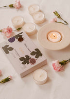 Set of three tealight candles in decorative tins from Mimi & August's Cielo Tealight Candle Set, featuring warm wax tart designs.