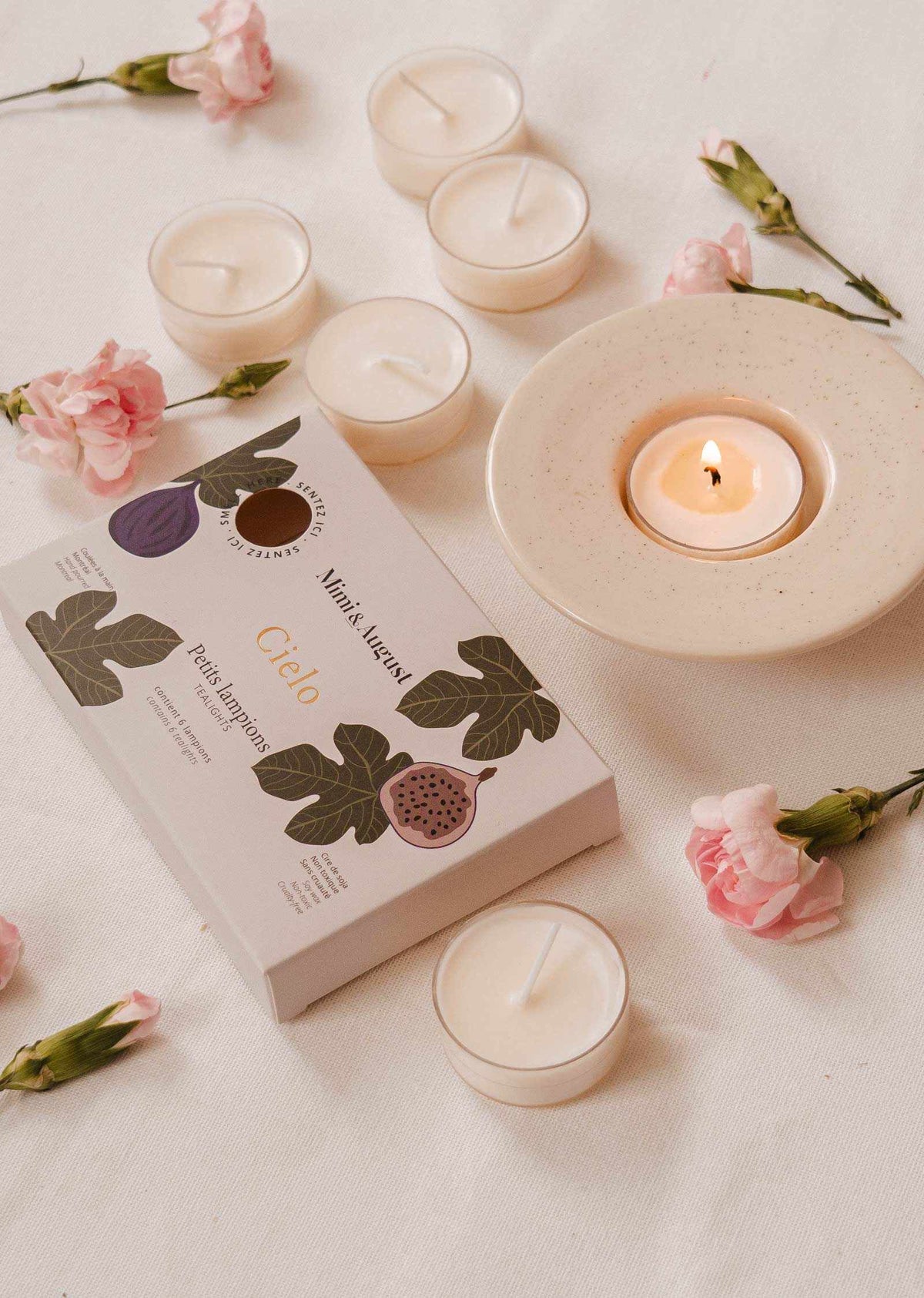 Set of three tealight candles in decorative tins from Mimi & August's Cielo Tealight Candle Set, featuring warm wax tart designs.