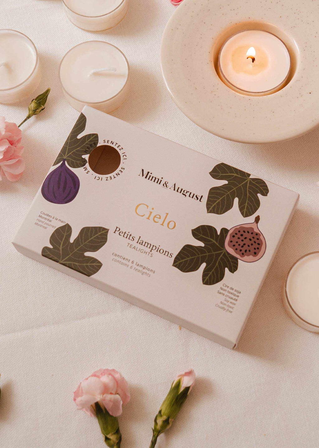Set of wax tealight candles from Mimi & August's Cielo Tealight Candle Set, featuring small, scented wax tart candles in a decorative display.