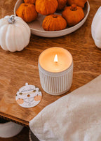 Reusable soy candle in a pumpkin-shaped container by Mimi & August, perfect for cozy home decor.