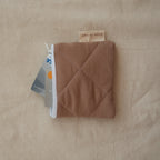 Reusable Dans Le Sac quilted cotton coin purse with a compact, stitched design and soft fabric exterior.