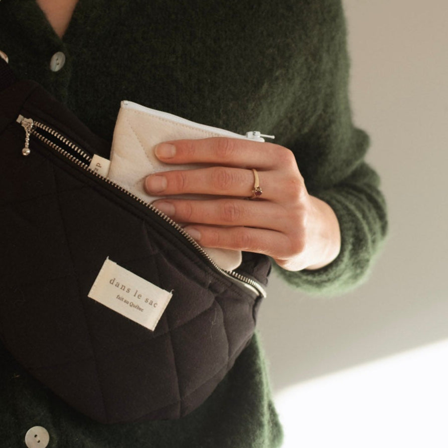 Reversible Dans Le Sac quilted cotton coin purse with zipper closure, featuring a soft, padded textured design.