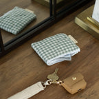 Reusable Dans Le Sac quilted cotton coin purse with a soft, padded design and compact size for easy carrying.