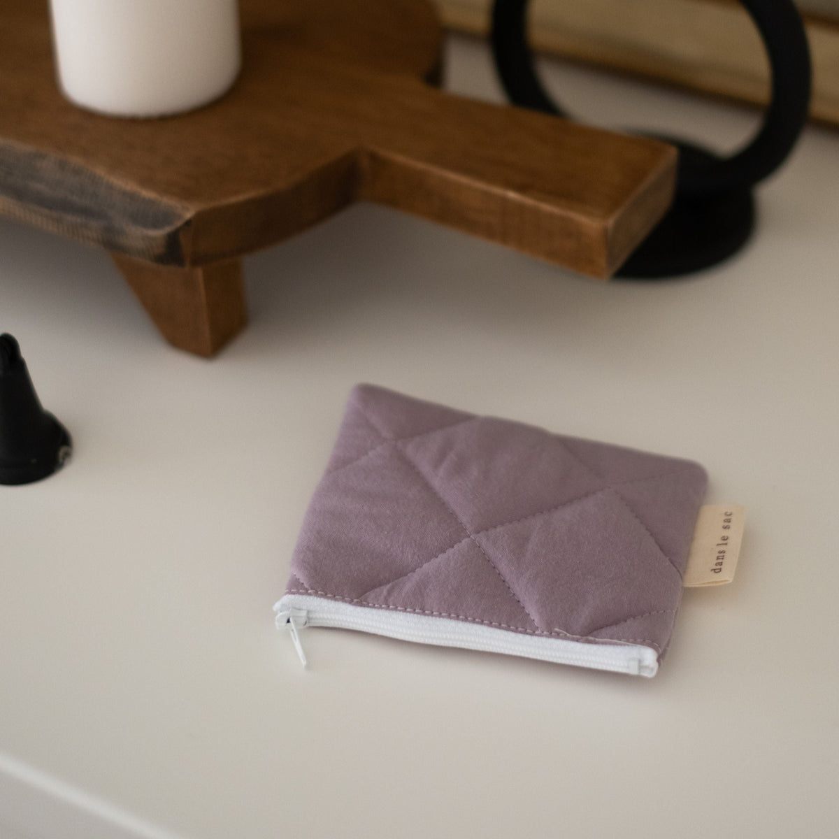 Reusable Dans Le Sac quilted cotton coin purse with a soft, textured fabric and compact design for everyday use.