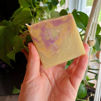 Handmade coconut milk soap by La Sultana Savonnerie with peach nectar, showcasing a creamy soap bar on a natural background.