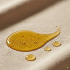 Organic 100% argan oil from Canadian Grace Wellness shown in a glass bottle, ideal for dry skin and frizz-prone, dehydrated hair.