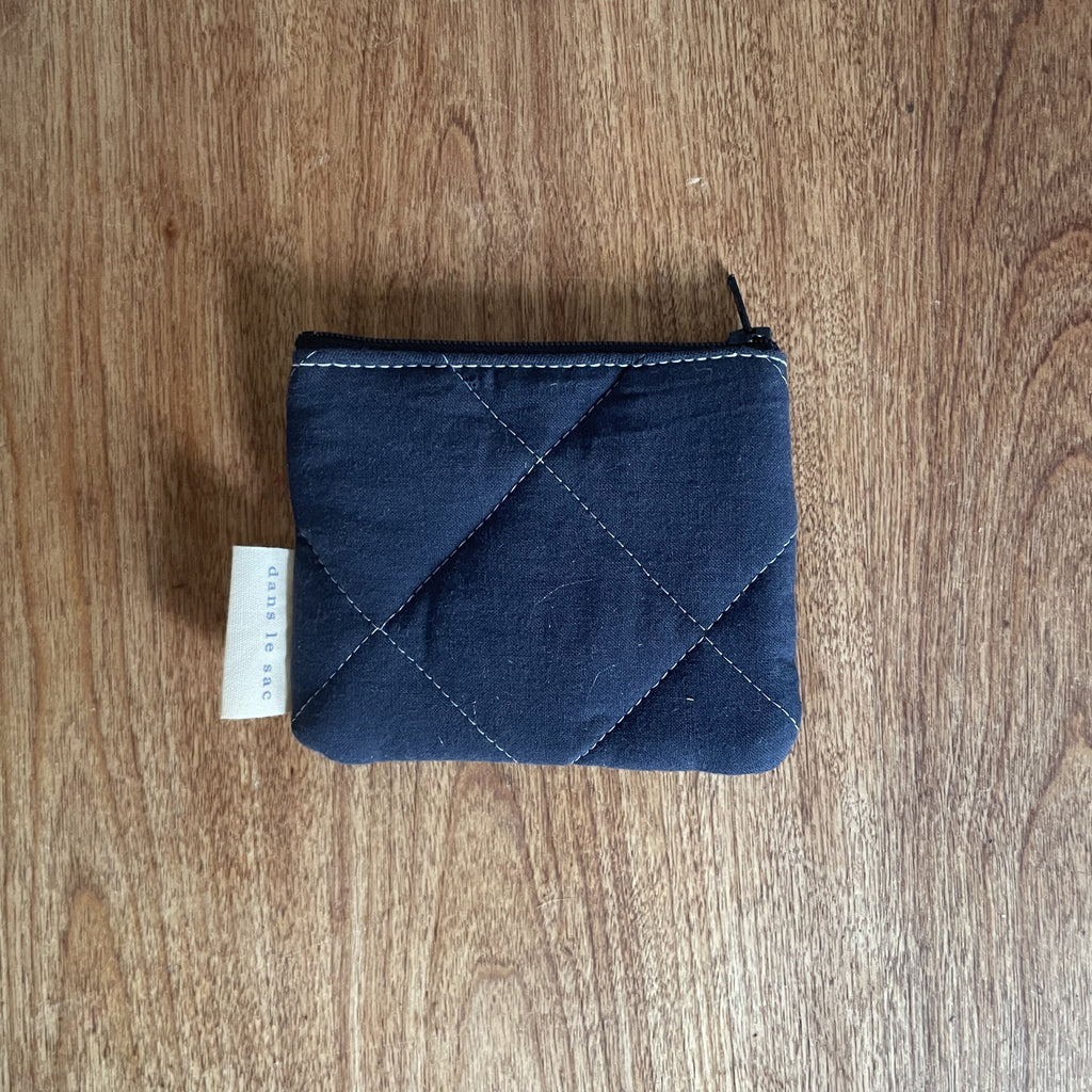 Reversible quilted cotton coin purse with zipper closure from Dans Le Sac, showcasing soft pastel colors and textured stitching.
