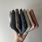 Reusable Dans Le Sac quilted cotton coin purse with a soft, padded design and compact shape for easy carrying.