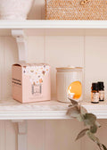 Mimi & August Lueur aromatic ceramic diffuser candle warmer with textured white ceramic design and soft lighting.