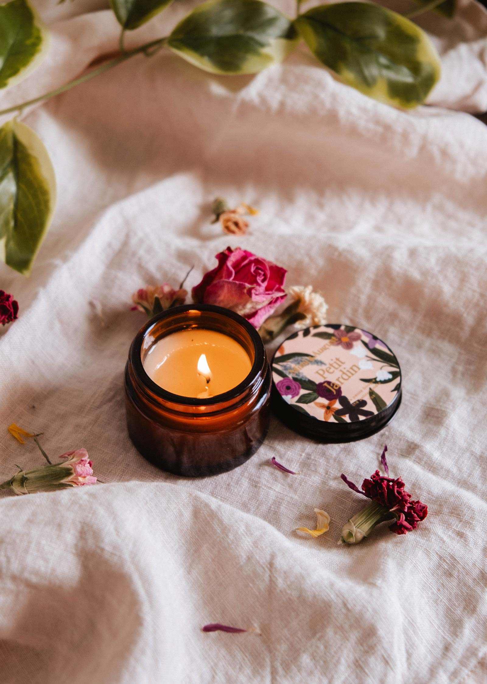 Petit Jardin 2 oz soy candle by Mimi & August, showing a small floral-scented candle in a clear glass jar.