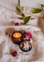Petit Jardin 2 oz soy candle by Mimi & August, small glass jar with botanical label and white wax interior.