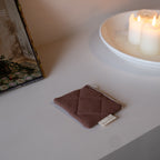Reusable Dans Le Sac quilted cotton coin purse with a compact, padded design and natural stitching.