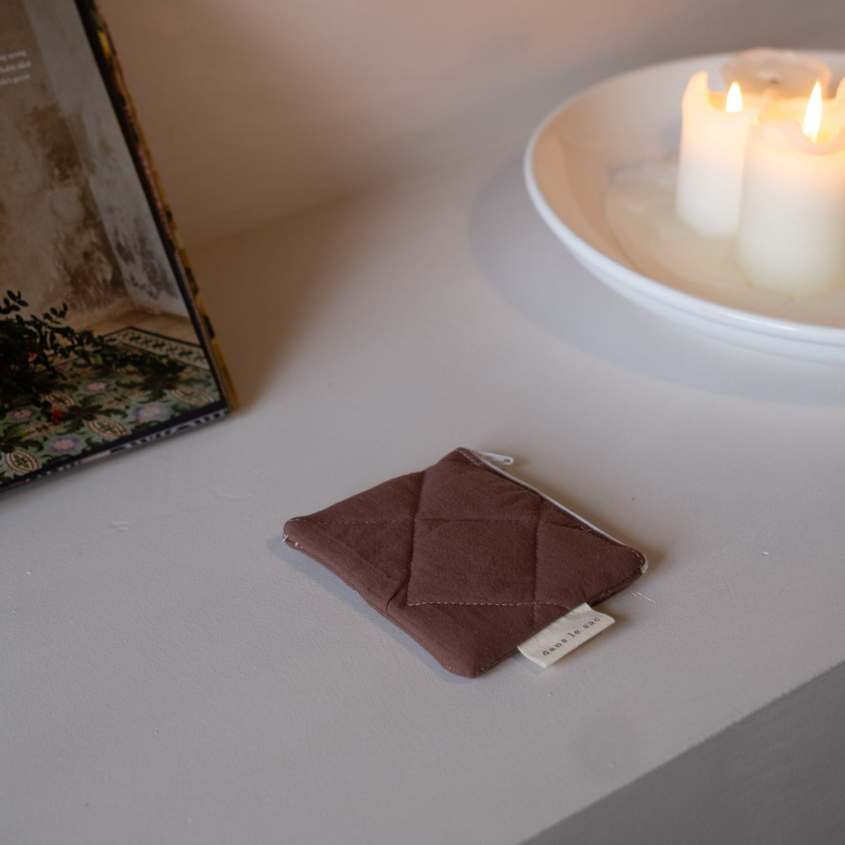 Reusable Dans Le Sac quilted cotton coin purse with a compact, padded design and natural stitching.