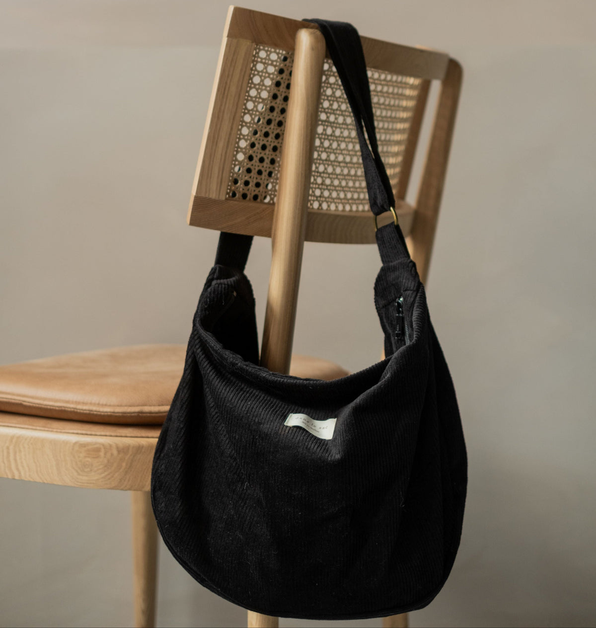 Reusable corduroy croissant bag with adjustable shoulder strap and zipper closure by Dans Le Sac