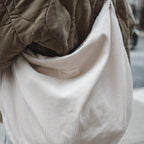 Dans Le Sac reusable corduroy croissant bag with adjustable shoulder strap and zipper closure, stylish and eco-friendly accessory.