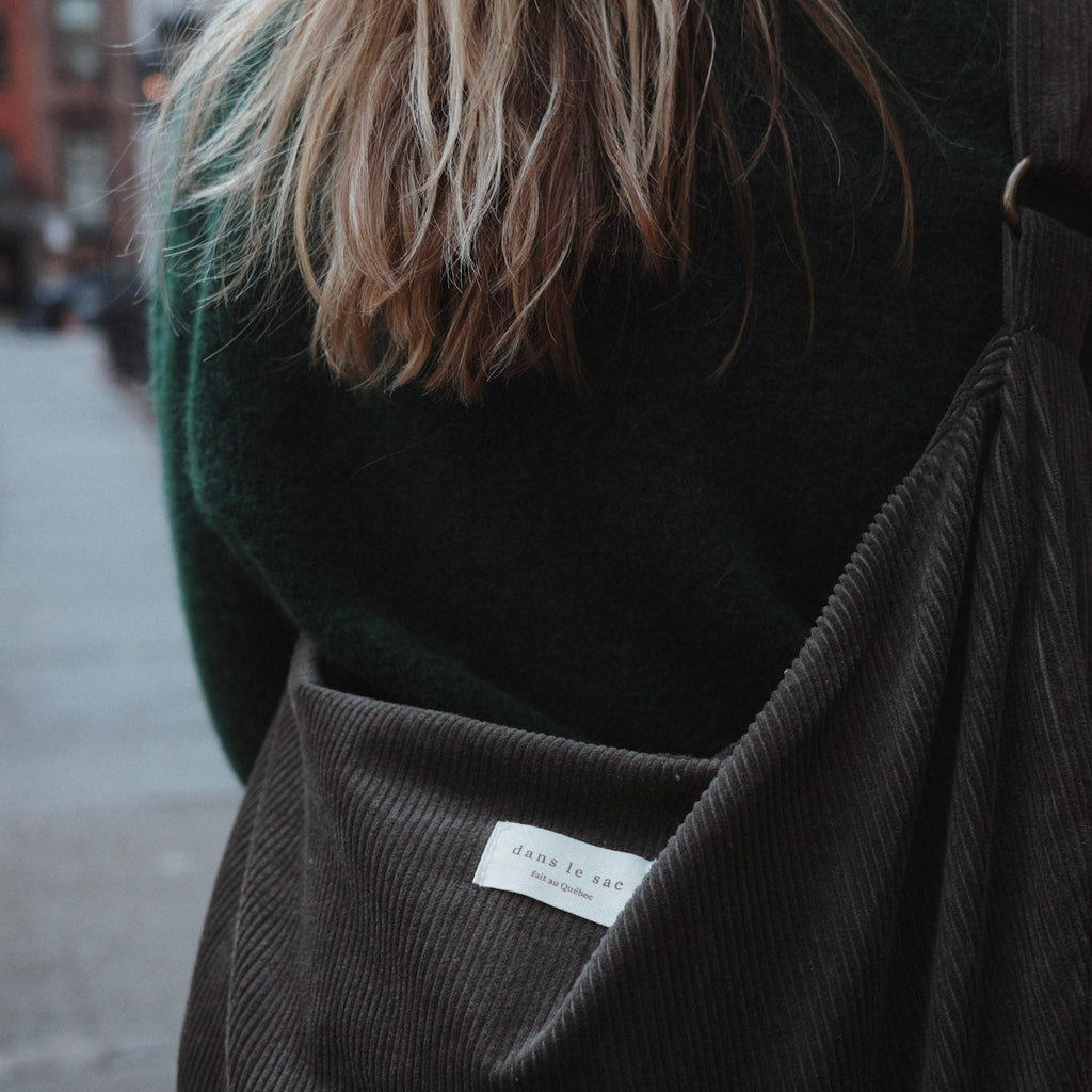 Reusable corduroy croissant bag with adjustable strap and zipper closure by Dans Le Sac, shown with a soft, textured fabric design.