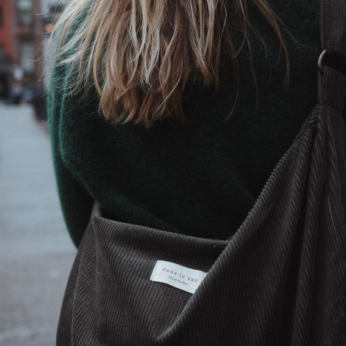 Reusable corduroy croissant bag with adjustable strap and zipper closure by Dans Le Sac, shown with a soft, textured fabric design.