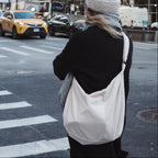 Reusable croissant-shaped corduroy bag with adjustable strap and zipper closure, stylish and practical from Dans Le Sac.