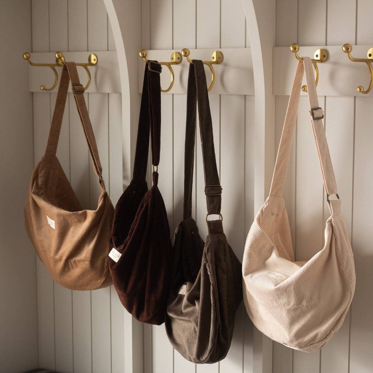 Croissant-shaped corduroy reusable bag with adjustable shoulder strap and zipper closure by Dans Le Sac