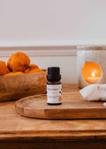 Mimi & August scented oil with pumpkin (Citrouille) aroma, showcasing a glass bottle with a metal cap and orange-hued oil.