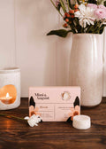 Soy wax melts in Bloom scent by Mimi & August, displayed as colorful wax tarts in a close-up image.
