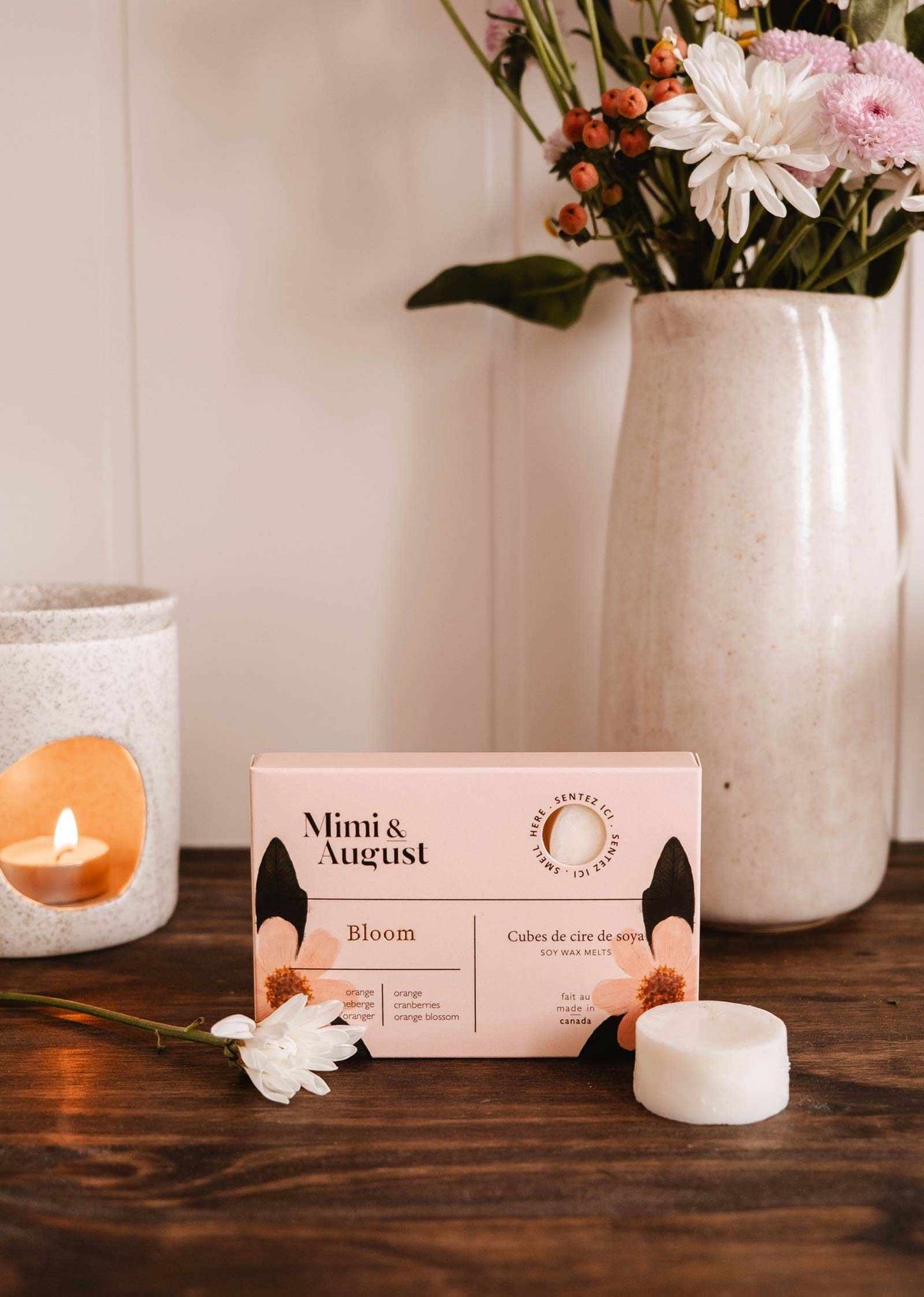 Soy wax melts in Bloom scent by Mimi & August, displayed as colorful wax tarts in a close-up image.
