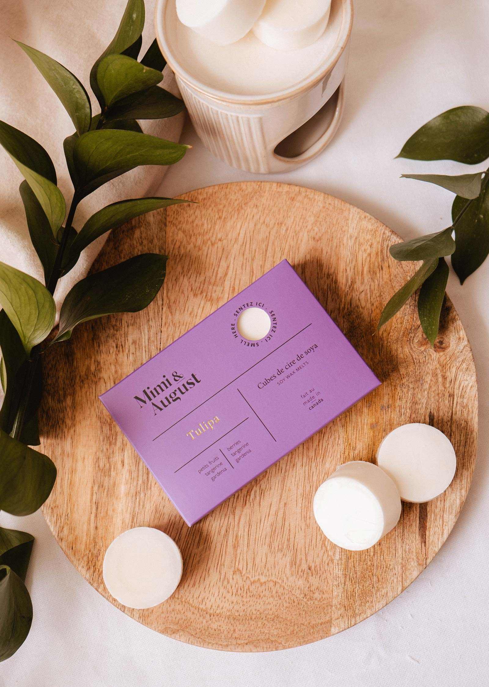 Soy wax melts in tulip scent by Mimi & August, featuring colorful wax tarts arranged in a decorative display.