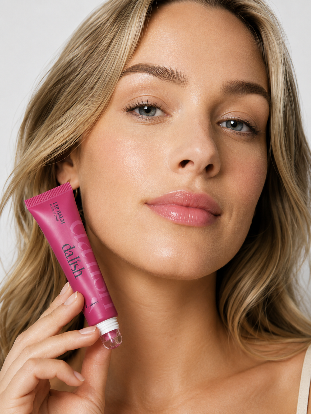 Da Lish Cosmetics hydrating tinted lip balm on model's lips, showcasing clean, buildable color for soft, healthy lips.