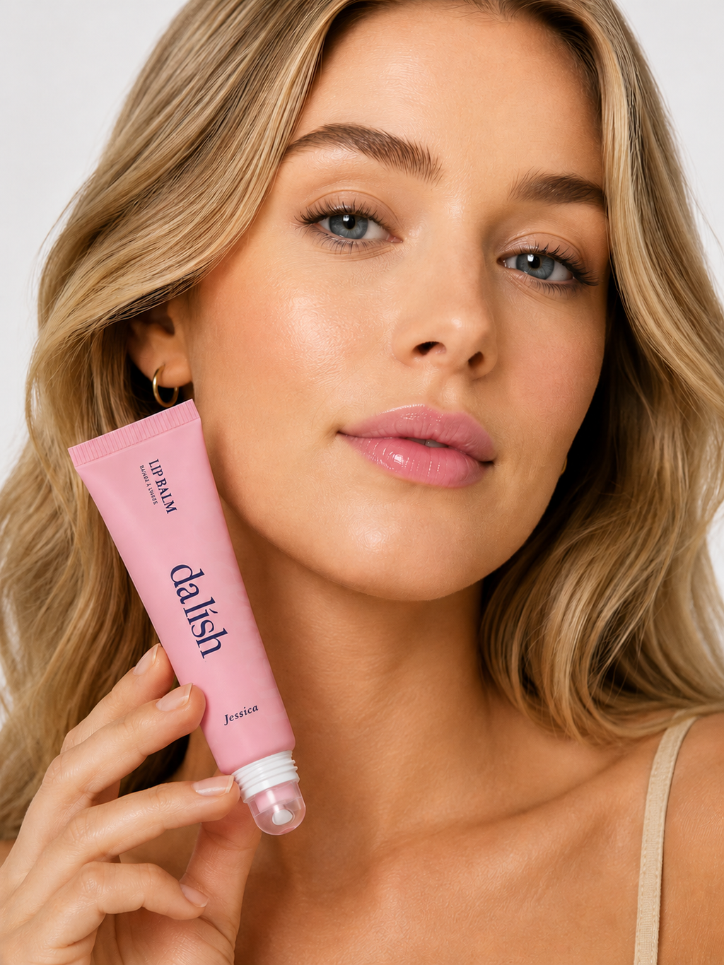 Hydrating tinted lip balm by da lish cosmetics applied on lips, showing natural, buildable color for soft, healthy-looking lips.
