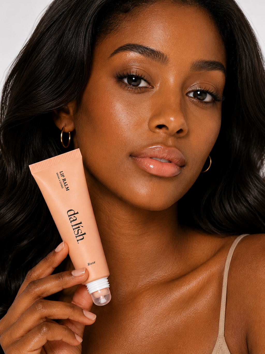 Hydrating tinted lip balm by Da Lish Cosmetics with soft, buildable rose-colored lip color and a smooth, healthy finish.