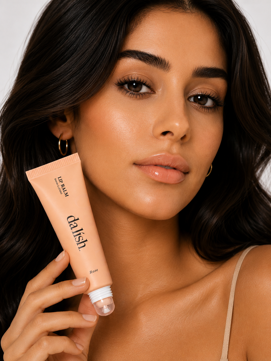 Hydrating tinted lip balm by da lish cosmetics in rose shade, showing soft, healthy lips with natural, buildable color.