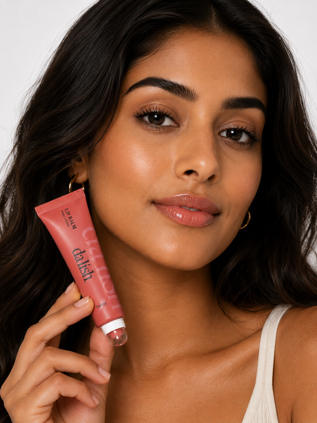 Hydrating tinted lip balm by da lish cosmetics with soft, buildable color on model's lips for a natural, healthy look.