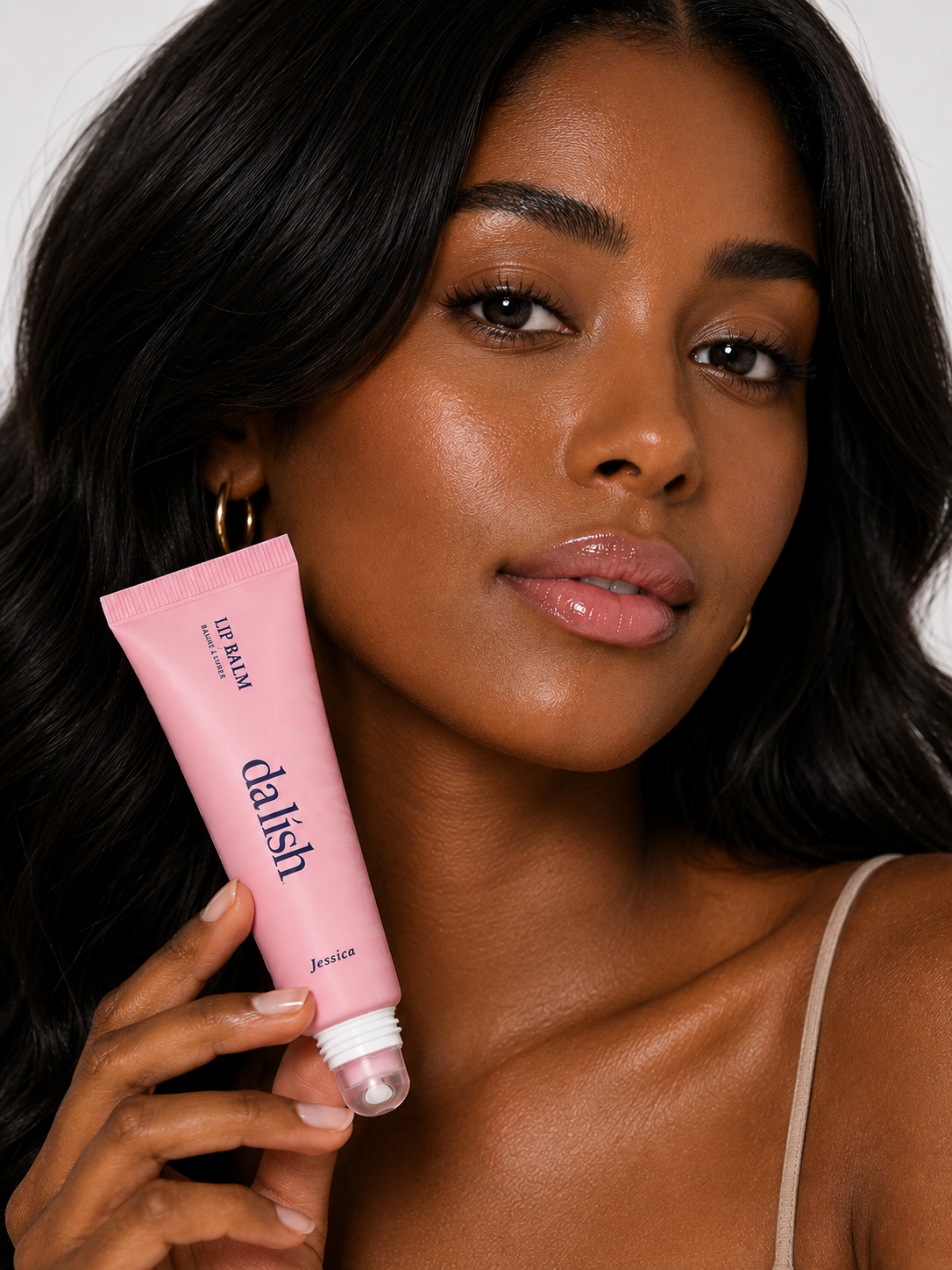 Hydrating tinted lip balm by da lish cosmetics on a model's lips, showcasing natural buildable color and soft, healthy-looking lips.