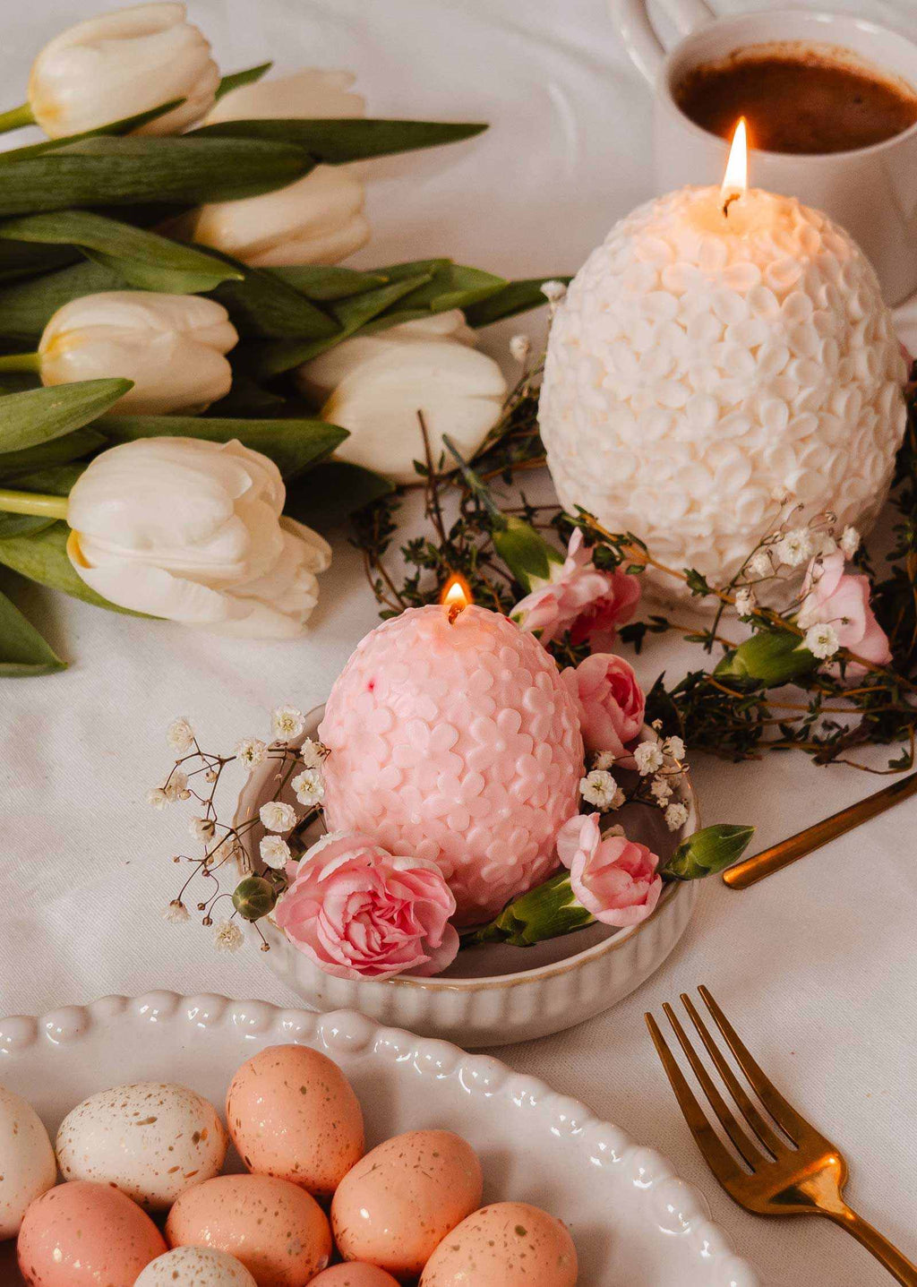 Decorative floral egg candle by Mimi & August featuring colorful floral patterns on a smooth, rounded candle shape.