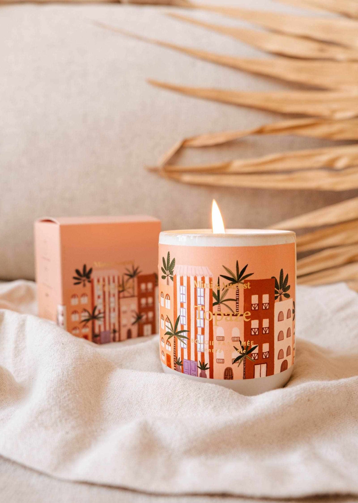 Topaze reusable 8oz candle by Mimi & August featuring a sleek glass container and a lit wick.